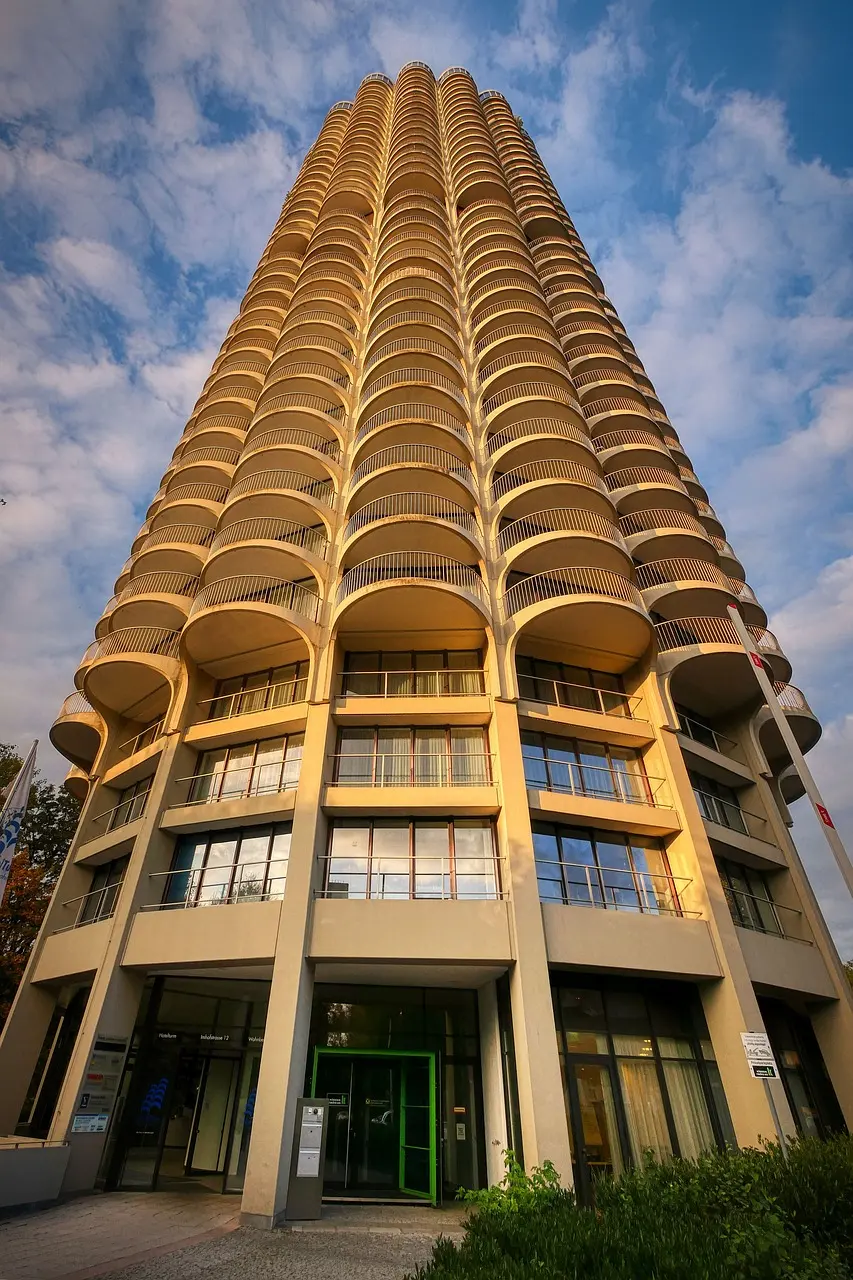 Balconied residential tower facade lit by late afternoon sun